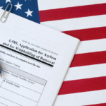 Form I-589 for asylum application on US flag.