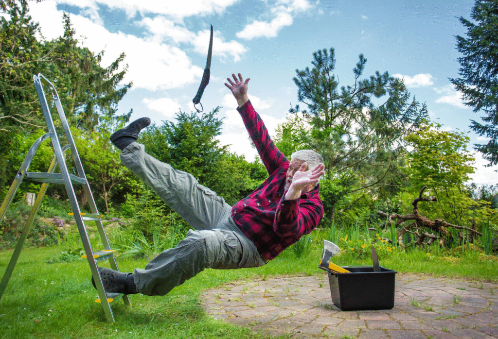 A Man slipping and falling off a ladder in a garden, saw flying through the air.