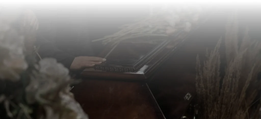 People placing flowers on a coffin.