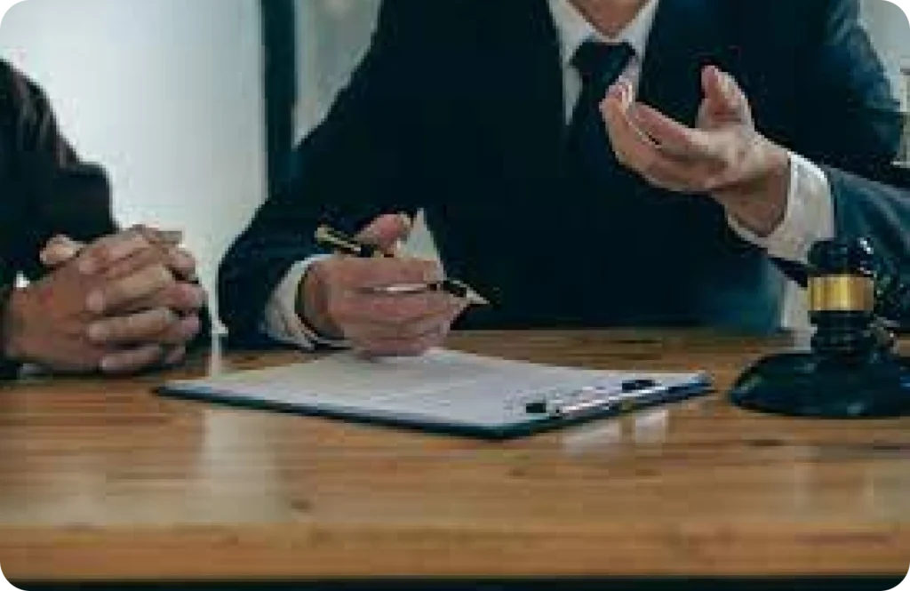People discussing over a table with documents.