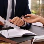 Lawyer presenting paperwork while discussing case settlements