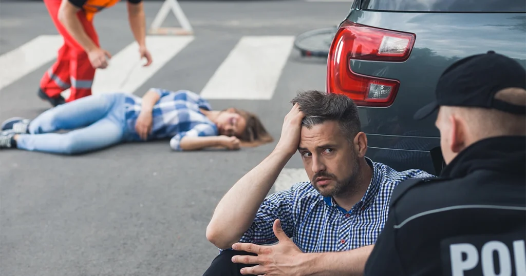 Man discussing fault with officer after car accident
