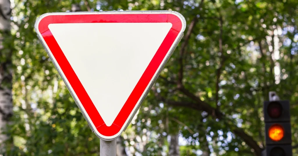 Yield traffic sign with red border and background